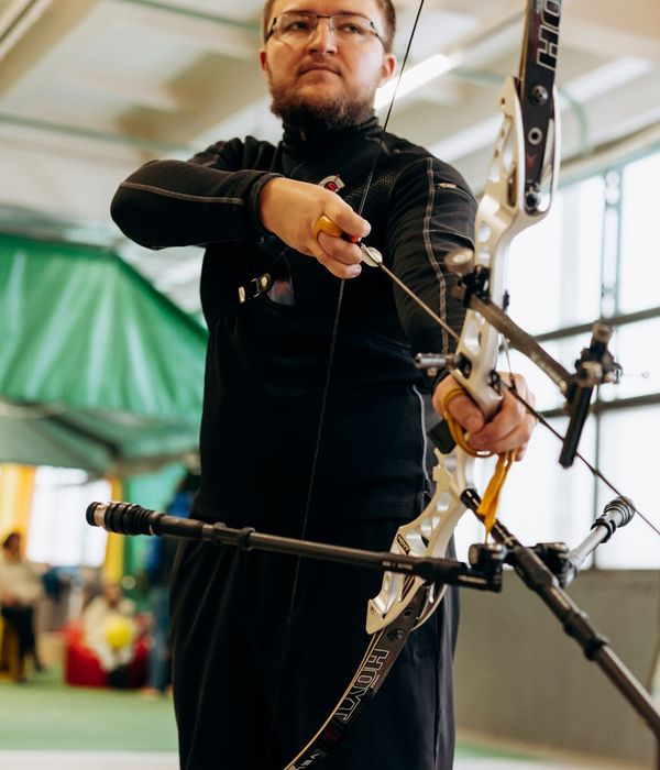 Person in a dynamic cardio-yoga posture, showing focus and balance.
