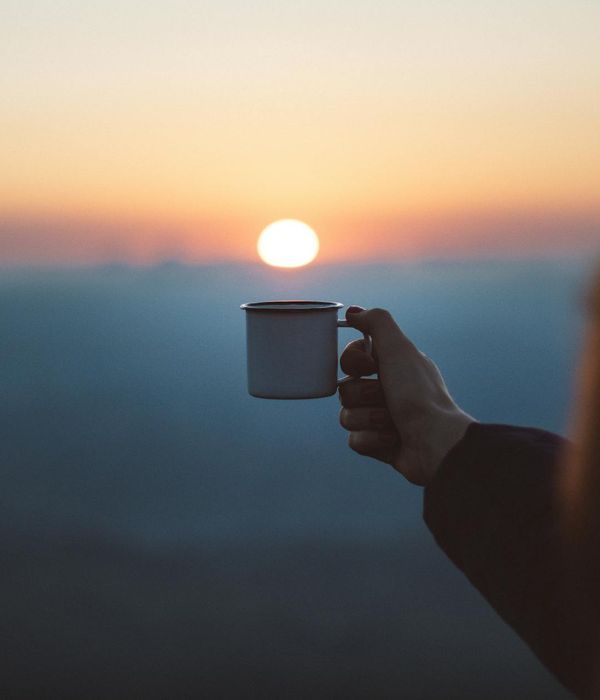 Silhouette of a person stretching at dawn, symbolizing a fresh start and consistency.